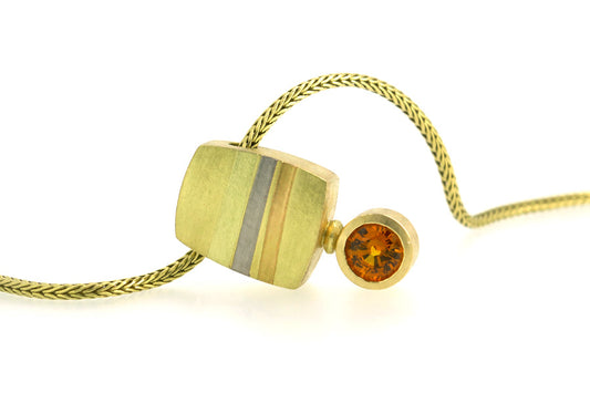 18ct yellow gold necklace with coloured gold details and set with orange sapphire