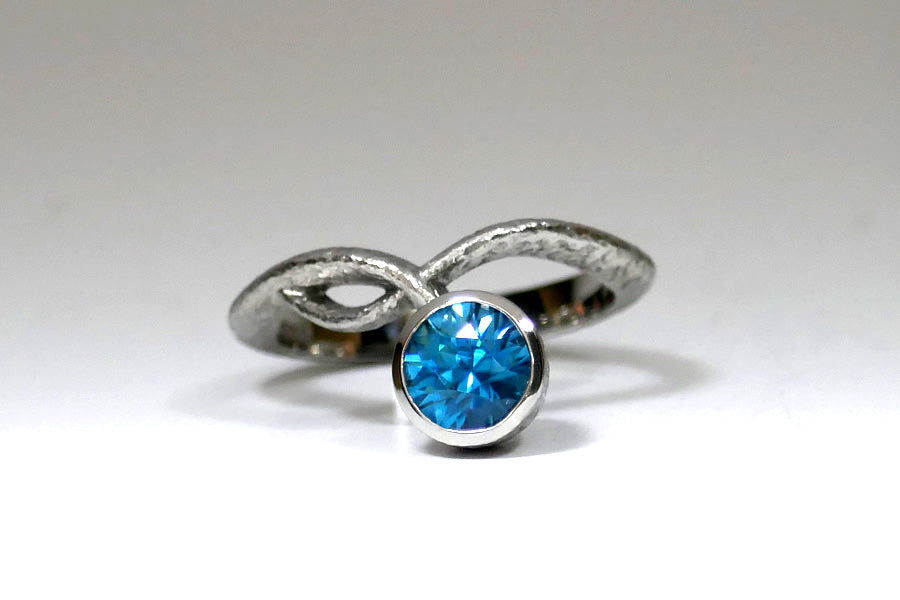 Blue Zircon Cross Through Platinum Ring