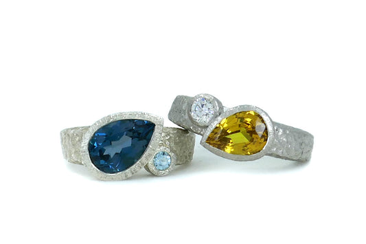 Pear Shaped Yellow Sapphire Platinum & Blue Topaz Silver Rings